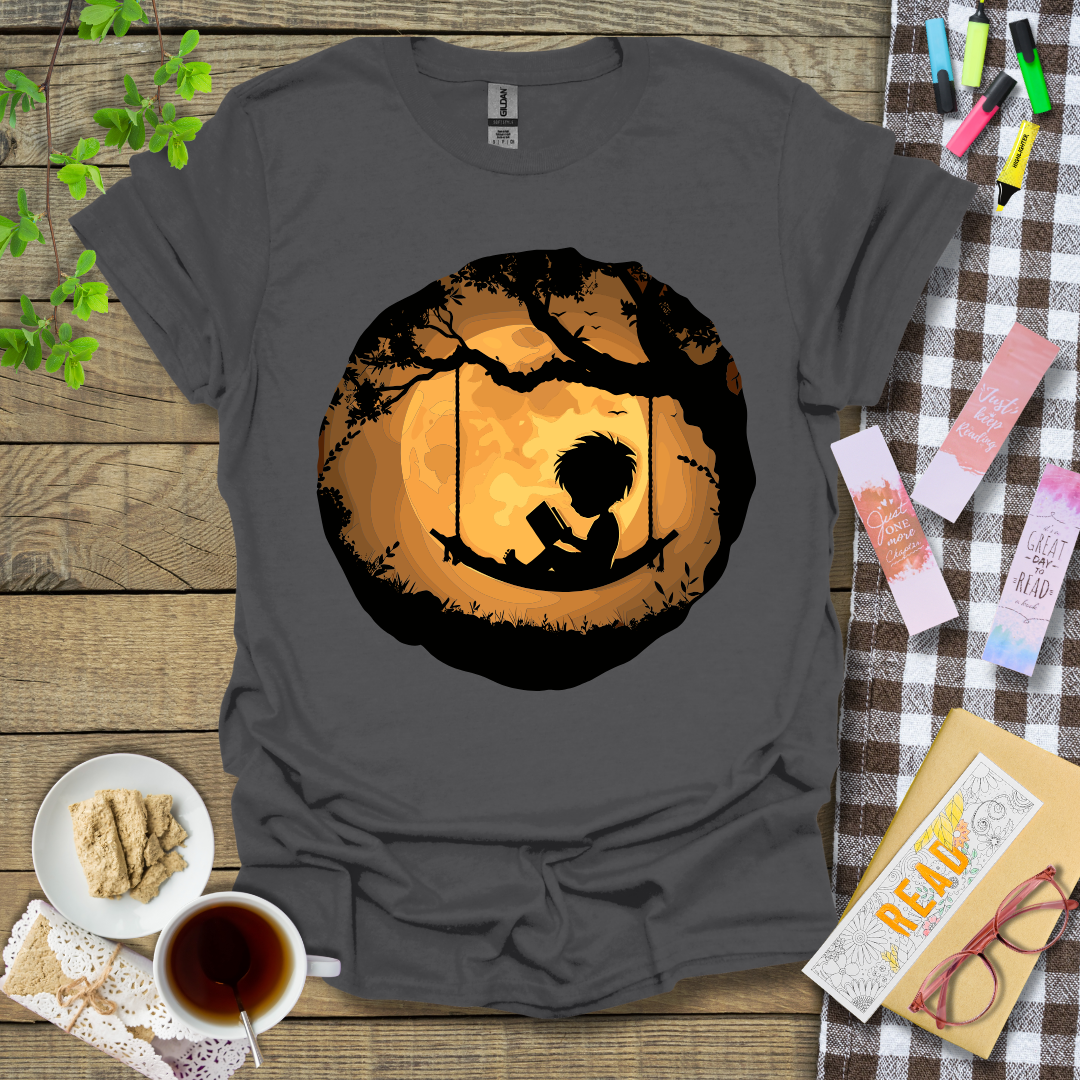 Boy Reading In A Swing Graphic T Shirt