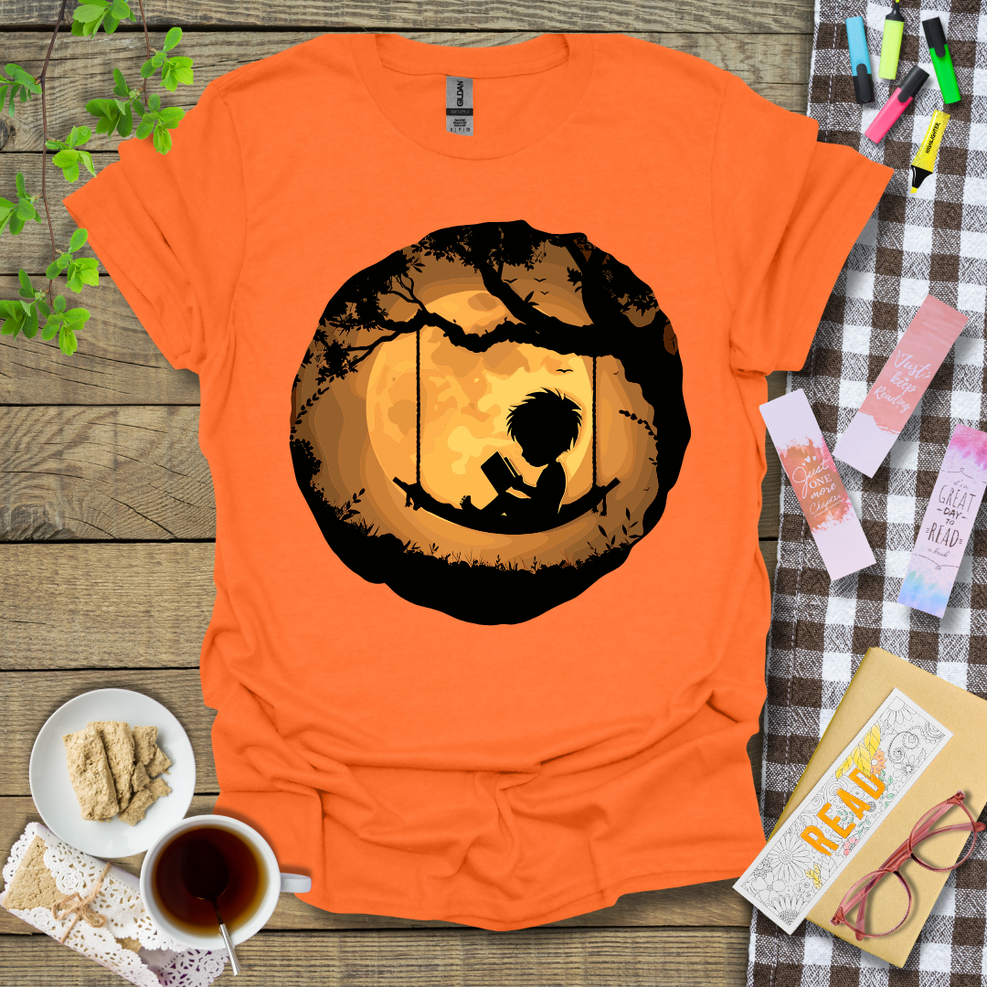 Boy Reading In A Swing Graphic T Shirt