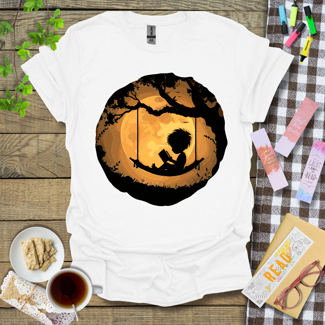 Boy Reading In A Swing Graphic T Shirt