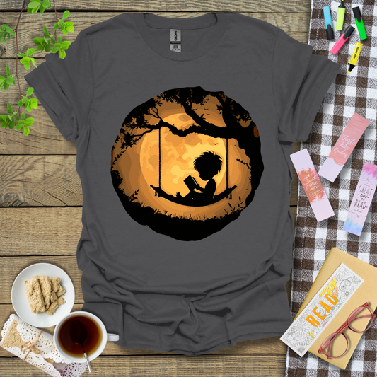 Boy Reading In A Swing Graphic T Shirt